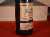 a bottle of wine sitting on a table next to a wooden box