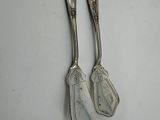 pair of silverware spoons on a white surface