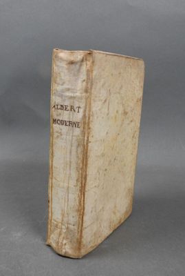 an old book sitting on top of a table next to a gray background