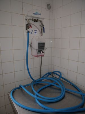 a blue hose that is connected to a white wall