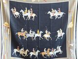 a black and white scarf with horses and jockeys on it