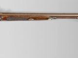 an old gun with a wooden handle on a white background