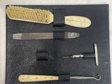 two brushes and a brush in a black case on a table