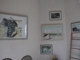 a picture of a bedroom with pictures on the wall