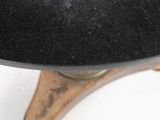 a black hat sitting on top of a wooden stand