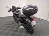 a motorcycle that is parked in a room with a checkered floor