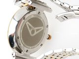 a close up of a watch on a white surface