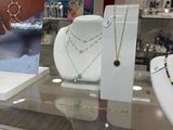 a display case with many different necklaces and bracelets on it