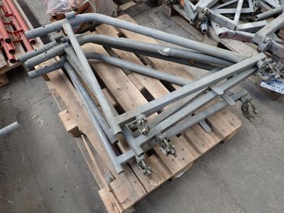 a pile of metal pipes on a pallet in a warehouse