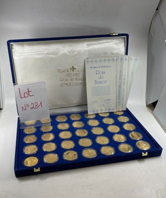 a box of gold coins with a note on top of it