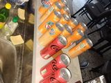 many cans of sodas on the counter in the kitchen