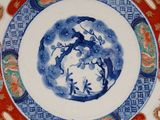 a blue and white plate with a design on it