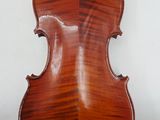 an antique violin on a stand with a white background