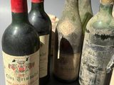 several bottles of wine sitting on top of a table next to each other
