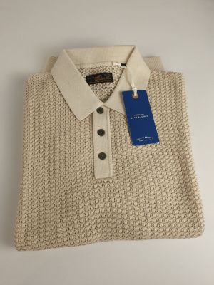 a white sweater with a blue tag on the collar