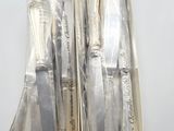 three knives in a box on a white surface