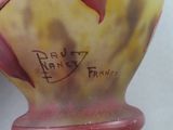 a vase that has a bird on it with writing on it