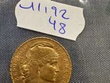 a gold coin with a label on it sitting on top of a table