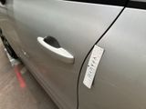 a sticker on the door of a silver car