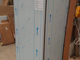 an image of a refrigerator in a warehouse with boxes around it