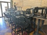 tables and chairs are lined up in a row in a restaurant