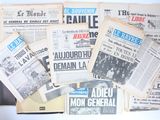 several newspapers are stacked on top of each other on a table