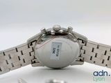 a close up of a watch on a white surface
