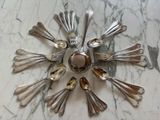 a lot of silver spoons and spoon spoons on the table