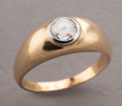 a close up of a gold ring with a white diamond