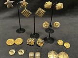 a collection of gold and silver earrings and brooches