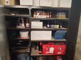 a pantry with a lot of bottles and boxes on the shelves
