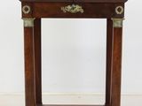 an antique wooden table with a marble top and brass accents