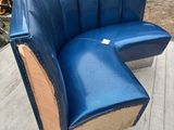 a blue leather chair that is sitting on a wooden floor