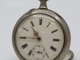 a silver pocket watch with roman numerals on the face