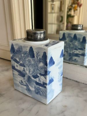 two blue and white vases sitting on a marble counter top