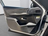 the interior of a car with the door open and the driver ' s seat down
