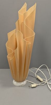 a lamp that is sitting on a table next to some wires
