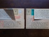 two old postcards on a table with a piece of paper sticking out of it
