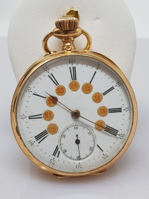 a gold pocket watch with roman numerals on it