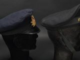 pair of military hats on mannequin heads against a black background