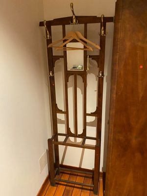 a coat rack in the corner of a room next to a door