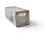 a box with a sticker on it sitting on a white surface