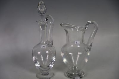 two glass vases sitting next to each other on a table