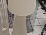 a lamp that is sitting on the floor next to a mirror