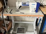 a sewing machine that is sitting on a table in a room