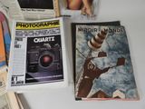 three magazines on a table with a camera on it