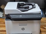 a printer sitting on top of a wooden table in a room