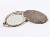 a silver locke with a mirror in it on a white surface
