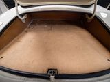 a trunk of a white car with the trunk open