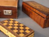 a small wooden box with a checker board inside of it